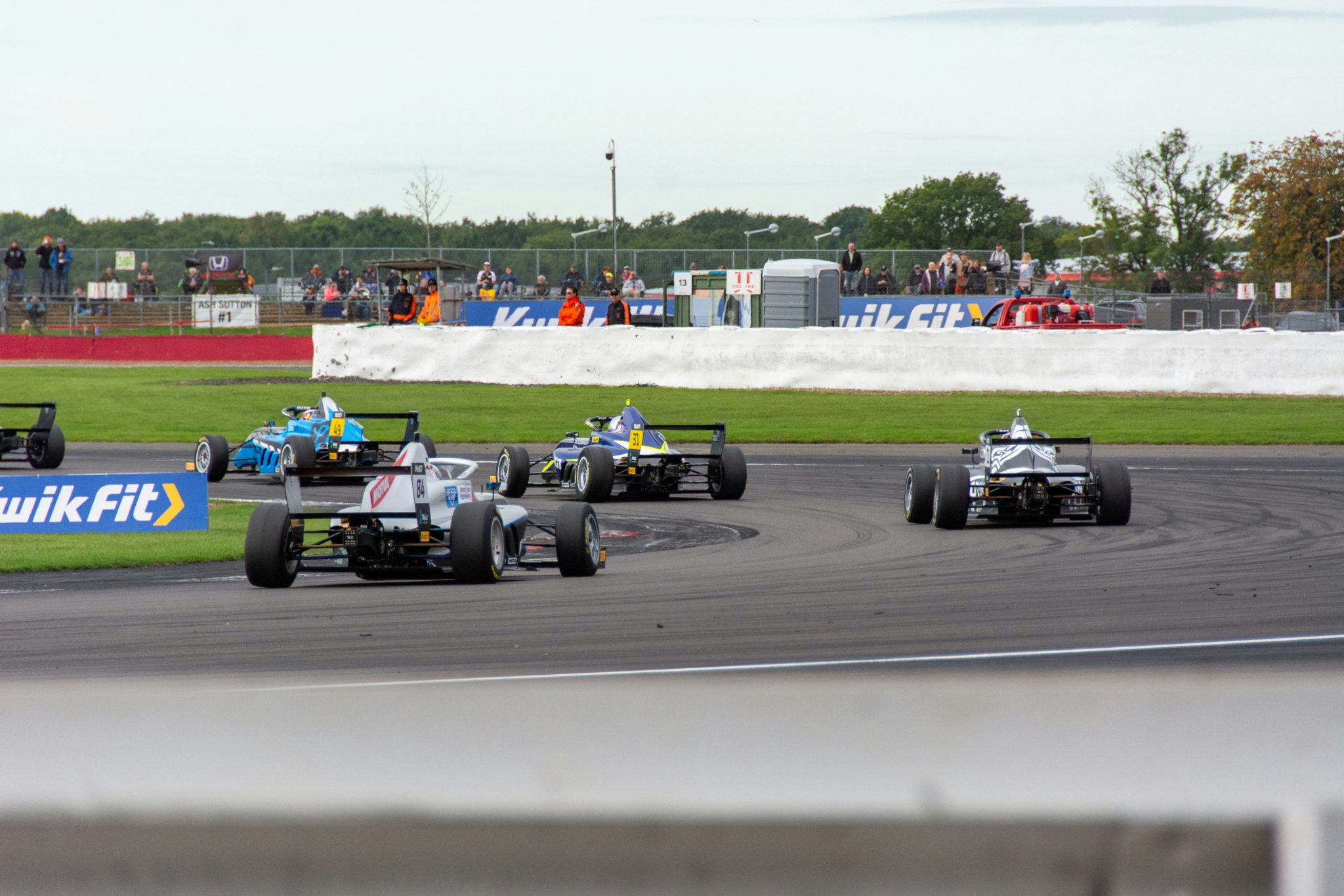 A field of race cars on track