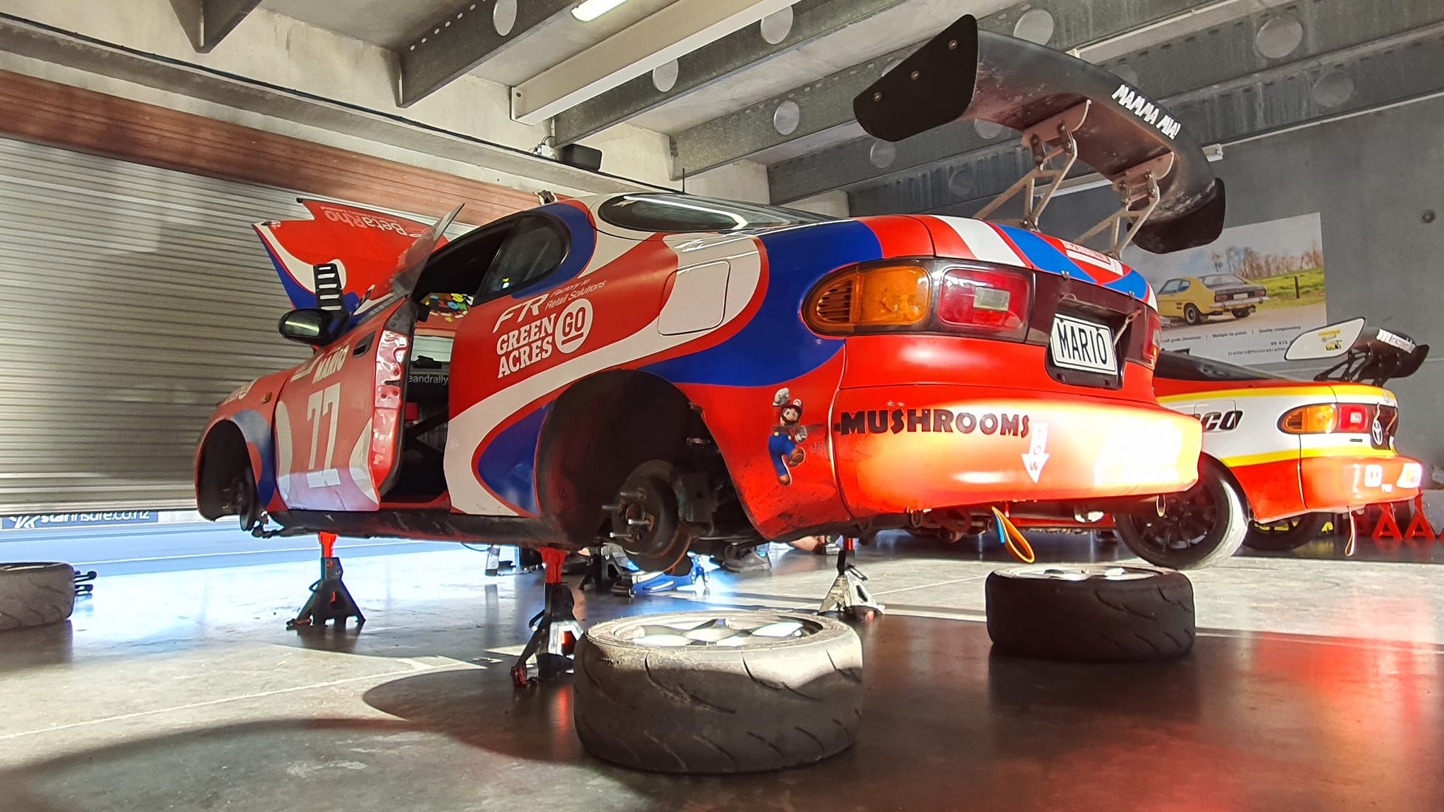 Race cars being prepared in the pits